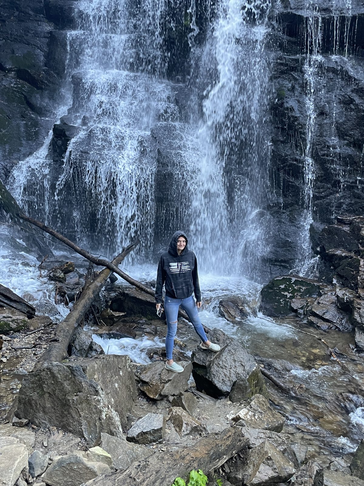 Students at a cascading waterfall in the Blue Ridge