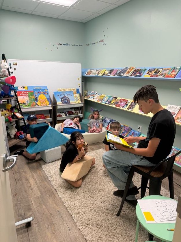 A teacher reading with a small group in the library