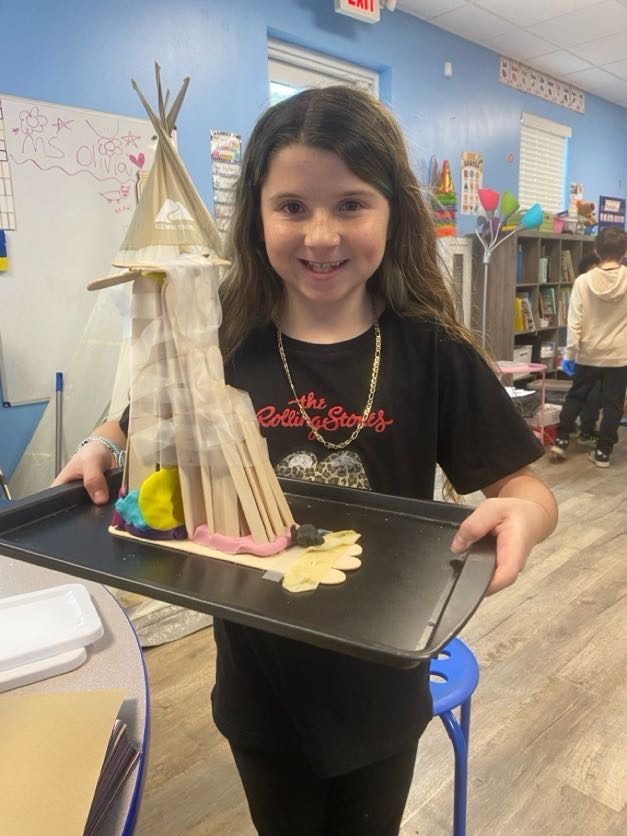 A student showing off a project she built