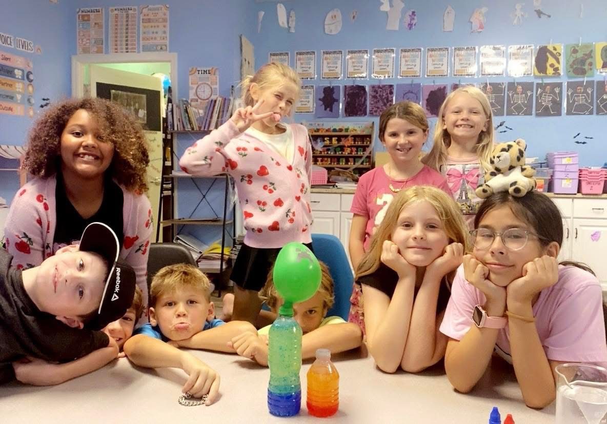 Students with a bubbling science experiment