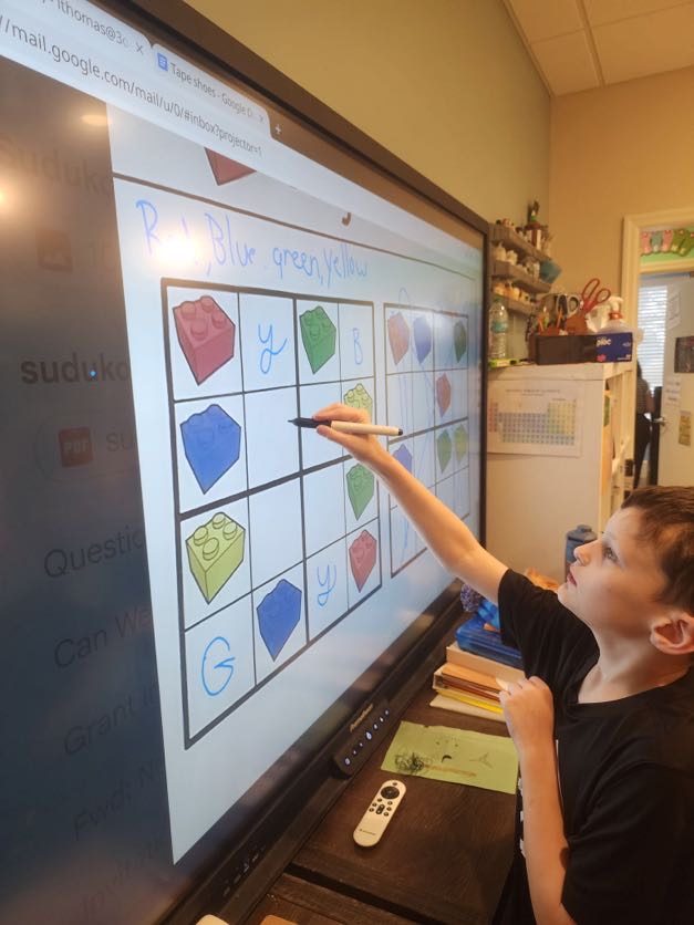 A student at the interactive whiteboard